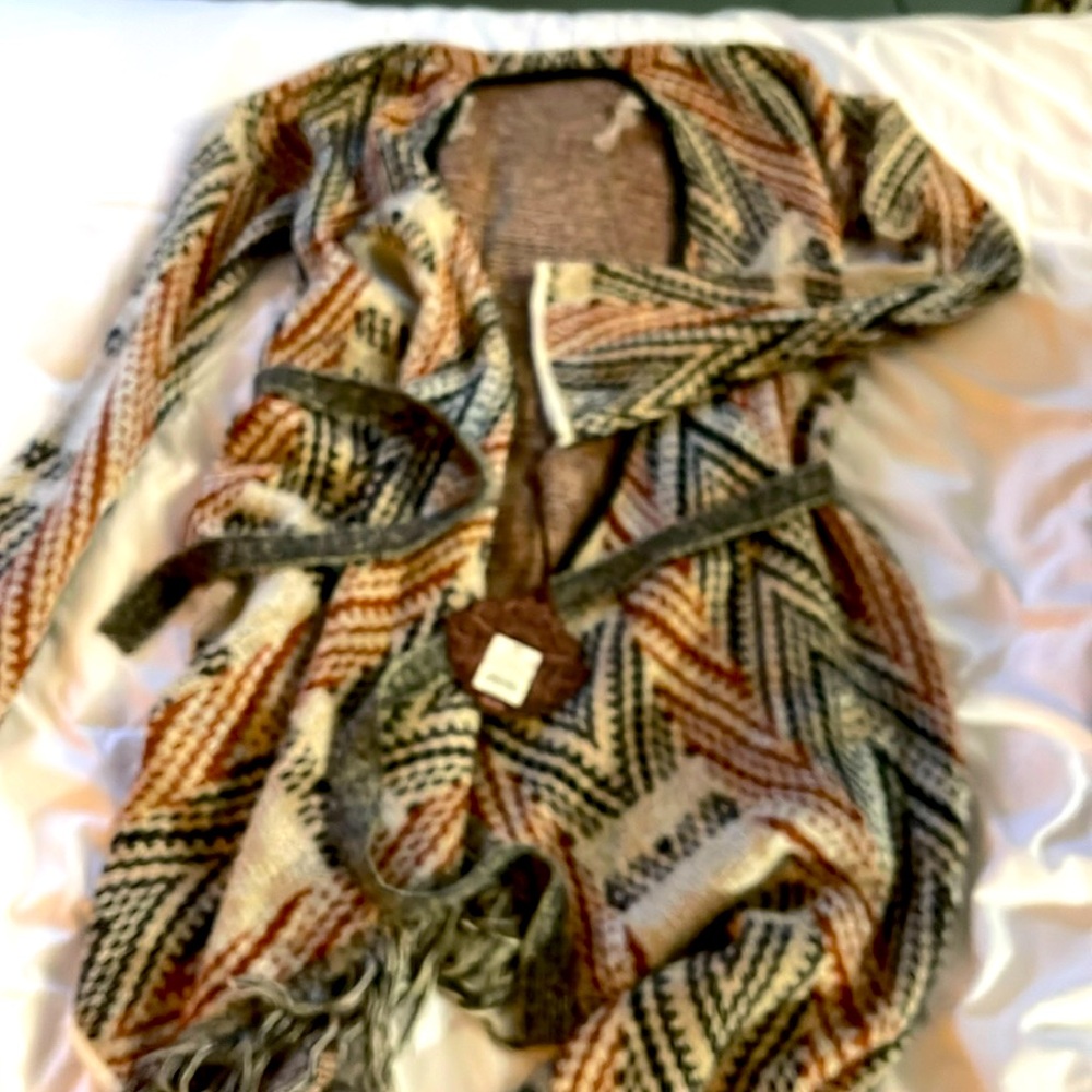 NWT wrap around patterned asymmetrical fringed bottom